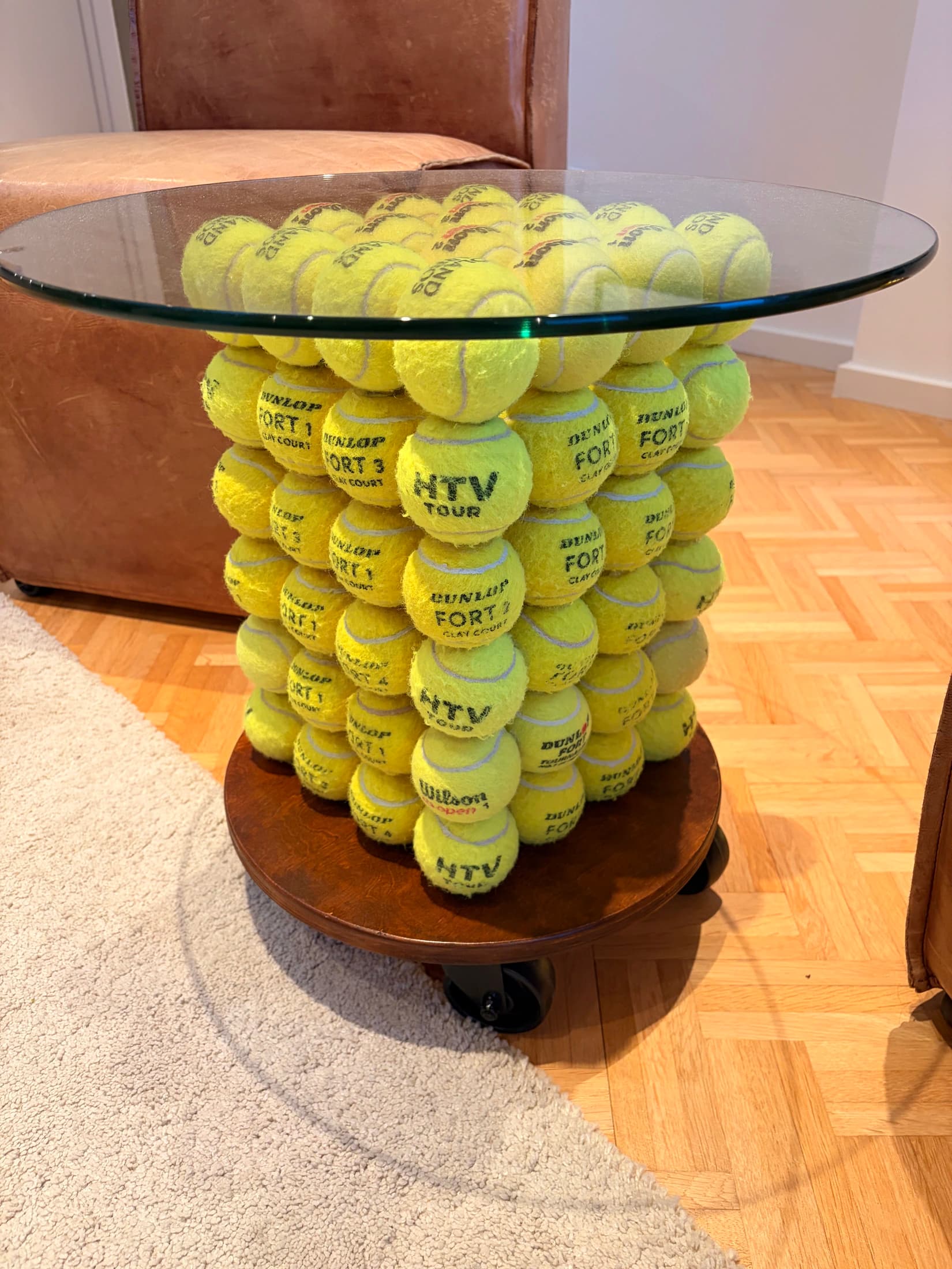 Coffee Table Boris No. 01 with its glass top, tennis-ball structure and wooden base