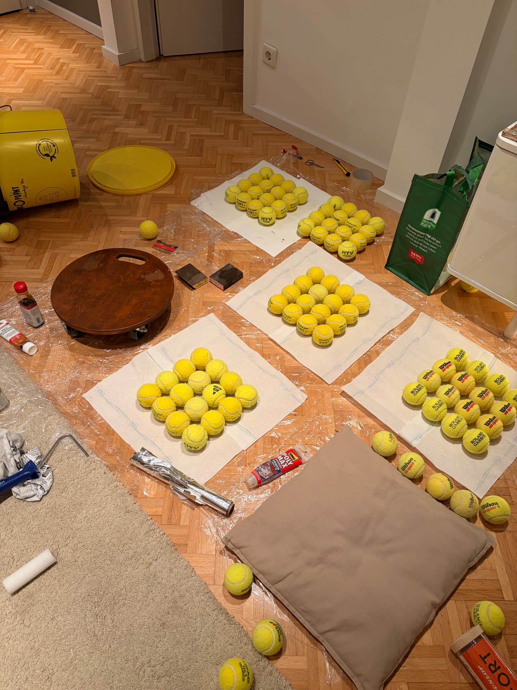 Tennis balls arranged by hand during construction