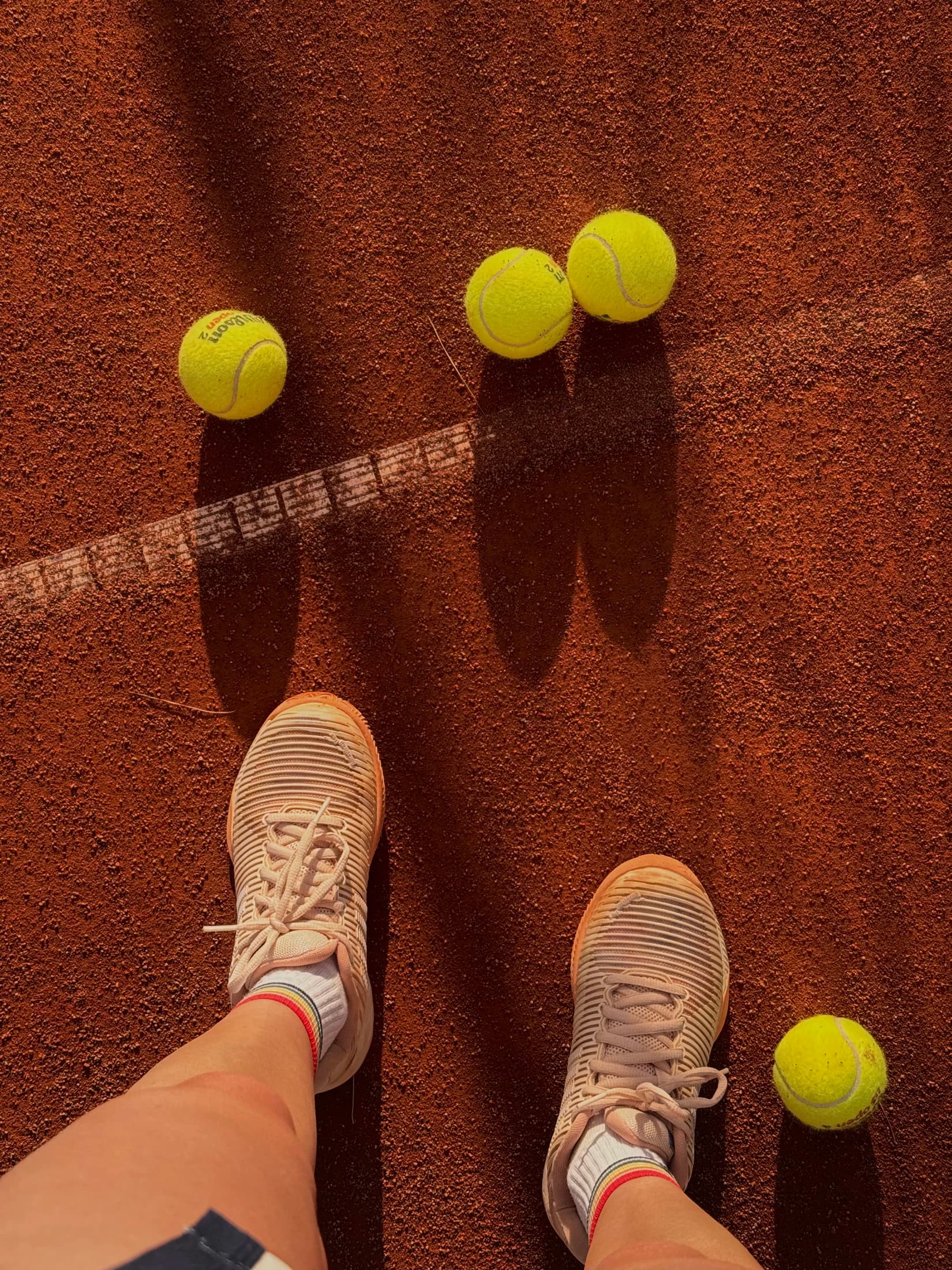 Played tennis balls on a clay court